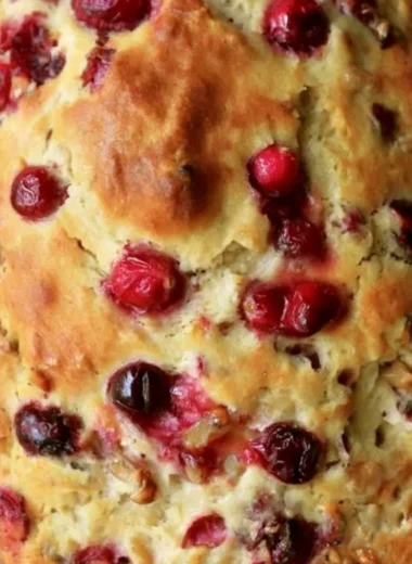 Sliced Mom's Cranberry Walnut Bread with cranberries and walnuts visible