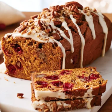 Delicious pumpkin cranberry bread loaf on a wooden table