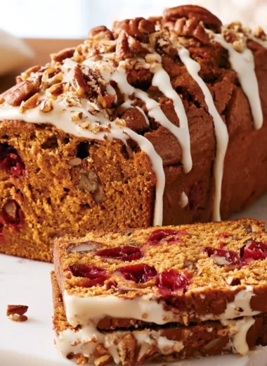 Delicious pumpkin cranberry bread loaf on a wooden table